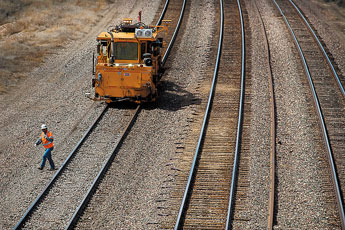 A railroad worker walks along the tracks near the Miyamura Overpass on Thursday afternoon.  © 2011 Gallup Independent / Brian Leddy 